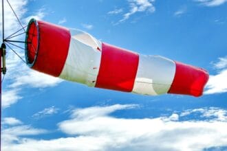 red and white flag under blue sky during daytime